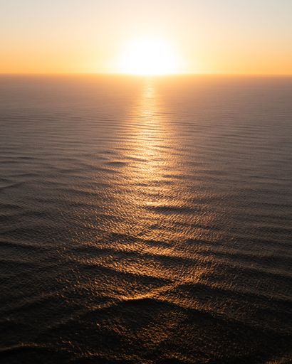 A vertical shot of soft waves of ocean water in sunlight