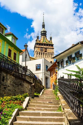 A clock tower surrounded by buildings in Sighisoara