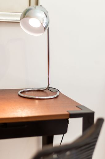 A vertical shot of a metallic silver lamp on a table