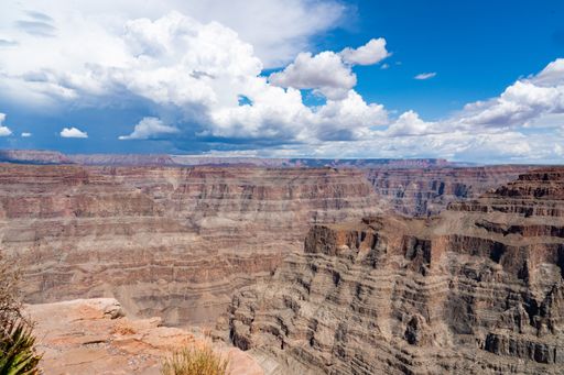An aerial view of sandstones in Grand Canyon National Park under blue cloudy sky in Arizona