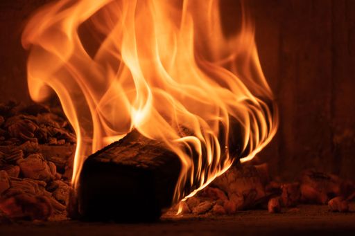 Image of a brick pizza oven with fire