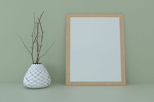 A 3d rendering of a blank frame leaning on a green wall near a flower pot