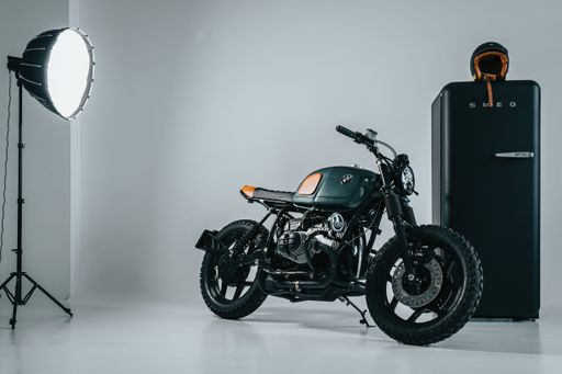 A photoshoot of a black motorcycle in a studio