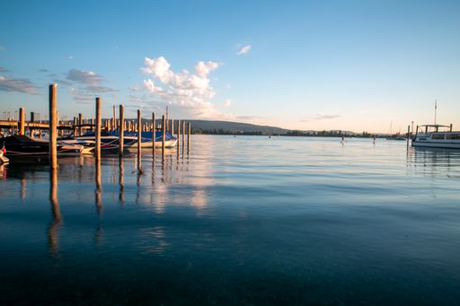 A beautiful shot of a lake pier with lots of boats