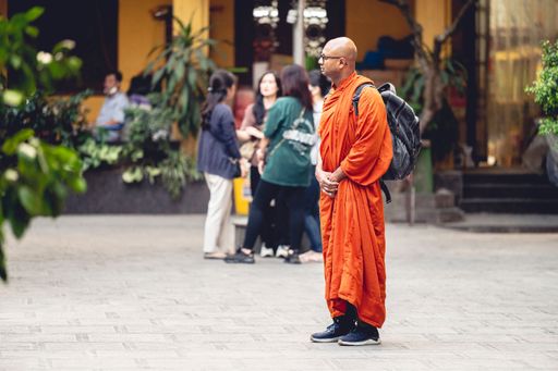 A young Buddhist monk walking around the area of a Buddhist temple in Hanoi, Vietnam