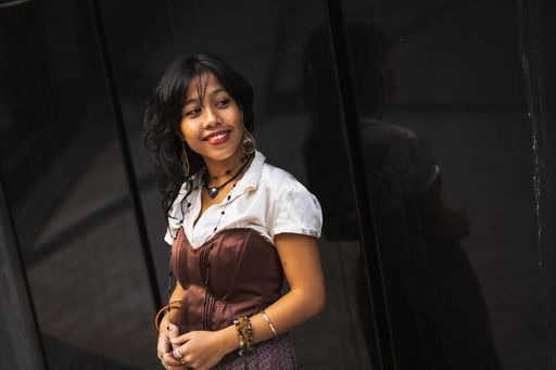 An Asian girl in vintage Asian traditional long dress posing for fashion on black background