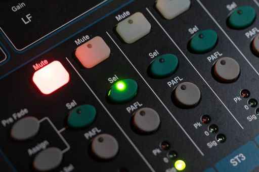 A closeup of buttons on an audio mixing device
