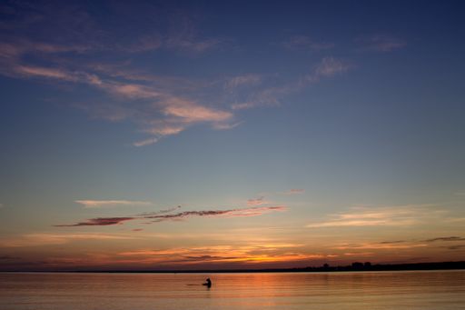 A closeup shot of the sea and cloudy sky during sunset