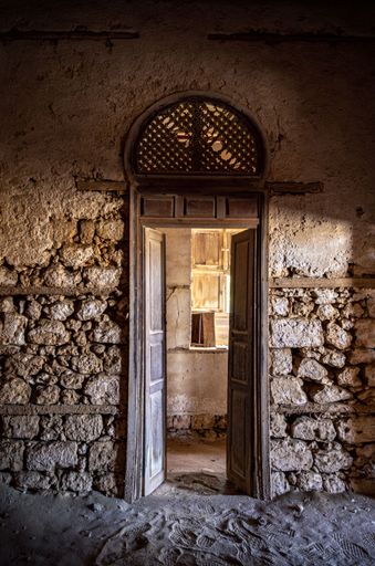 A Vertical shot of the open door of the old and demolished building