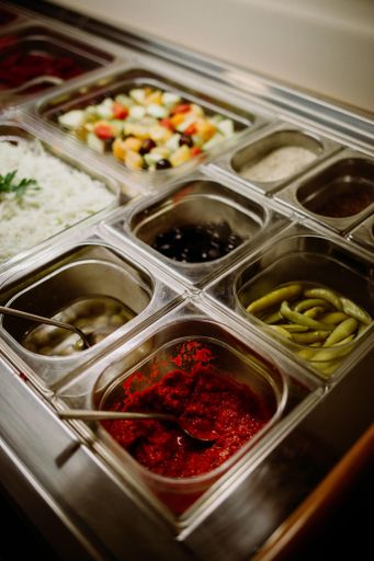 A vertical high angle shot of various foods at a buffet