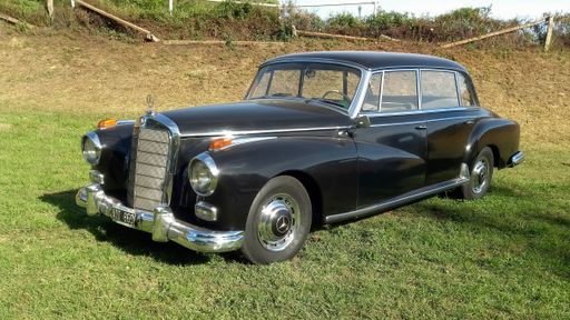 Old black 1950s Mercedes Benz 300 W186 Adenauer luxury sedan in the countryside. Sunny day. Autoclasica 2022 classic car show.