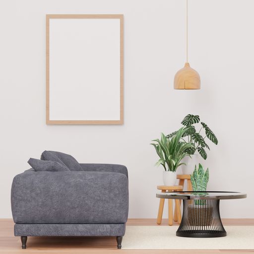 A 3d rendering of a loft-style living room with a white wall, sofa,  mockup frame, and plants.