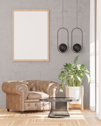 A 3d rendering of a loft-style living room with a white wall, sofa,  mockup frame, and plants.