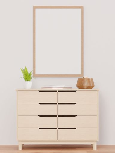 A 3d rendering of a living room with a white wall, drawer, plant, and a mock-up frame.