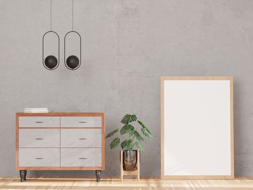 A 3d rendering of a loft-style living room with a concrete wall, drawer, plant, and a mock-up frame.