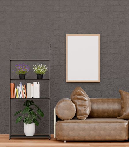 A 3d rendering of a loft-style living room with a black brick wall, sofa,  mockup frame, and plants.