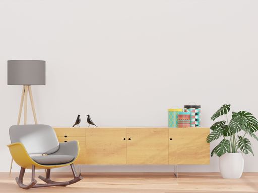 A 3D rendering of a living room with a white wall and wooden sideboard