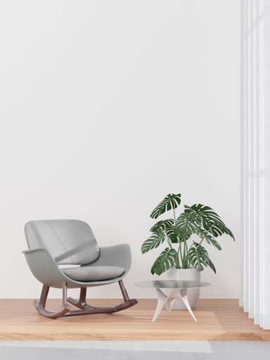 A 3D rendering of a living room with a white wall and gray sofa