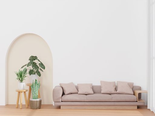 A 3D rendering of a living room with a white wall, pink sofa, and a plant