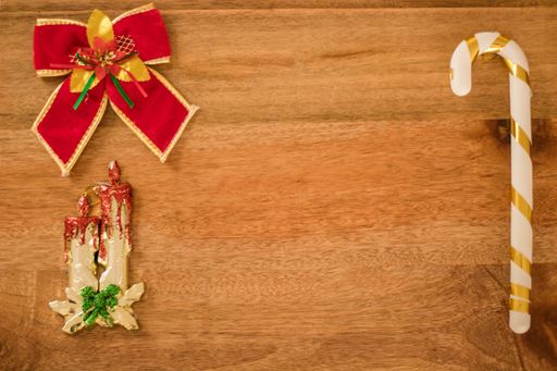 A top view of Christmas decorations on a wooden table with copy space