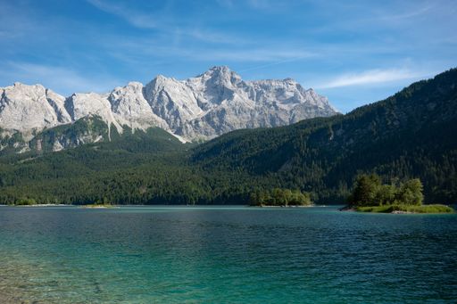 A beautiful shot of the Eibsee Lake and nearby rocky mountains in Germany