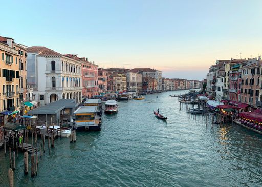 A beautiful view of a gondola on the Grand Canal in Venice at sunset