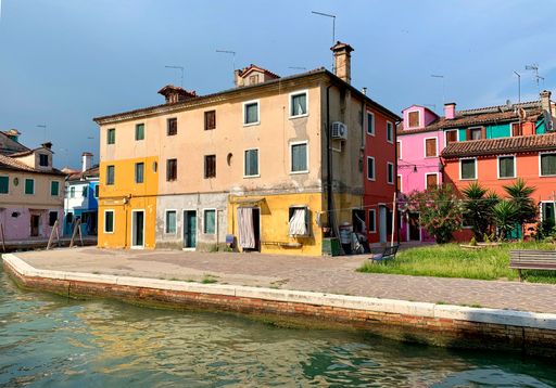 A beautiful shot of colorful houses on the shore of the canal in Burano, Italy