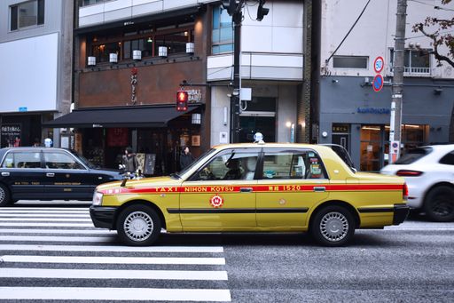 A yellow taxi moving in the street