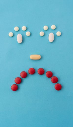 A sad emotion with pills in blue background