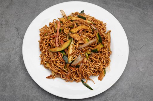 A top view shot of vegetable yakisoba on a rustic background