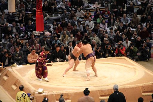 A high angle shot sumo wrestlers compete in a championship in Fukuoka in front of an audience