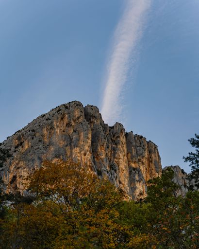 A vertical shot of the hiking area Sentier Blanc-Martel with colorful trees in autumn
