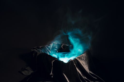 A closeup of an abstract blue smoke on a dark background