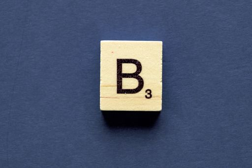 The letter B on a wooden cube from a wordplay board game