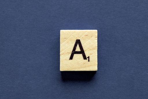 The letter A on a wooden cube from a wordplay board game