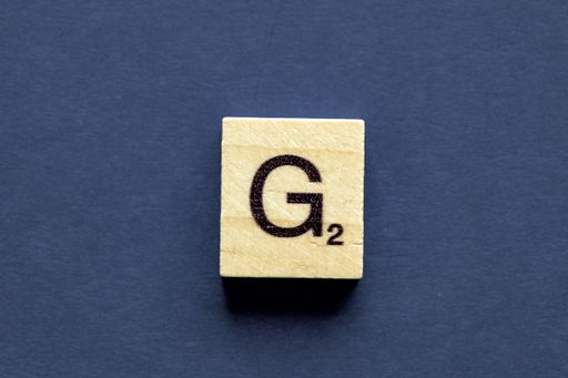 The letter G on a wooden cube from a wordplay board game