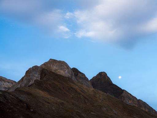 A low angle shot of a rocky hill