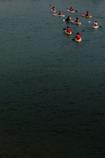 A vertical shot of a group of kayakers.