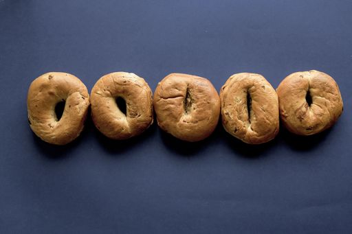 A dark blue surface with doughnuts in a line