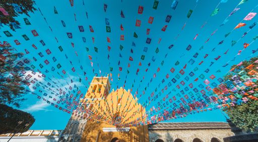 A low angle shot of the colorful pennants in front of the Saint Dominic's temple in the magic town of Comitan, Mexico