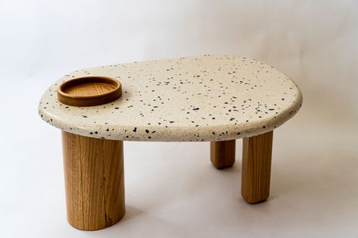 A single round white table on a white background.