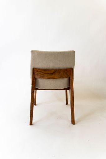A vertical shot of a modern wooden chair with fabric isolated on a white background