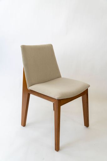 A single white round chair on a white background.