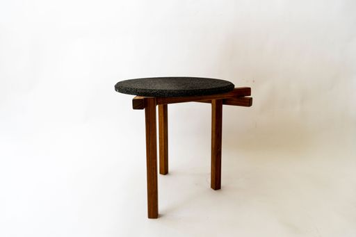 A single black round chair on a white background.