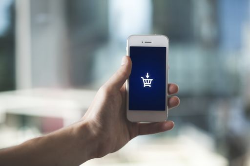 A shallow focus shot of a hand holding a smartphone