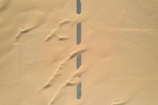 A closeup shot of roads of unfinished construction covered by the desert sands in the United Arab Emirates