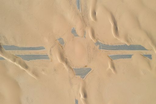 A closeup shot of roads of unfinished construction covered by the desert sands in the United Arab Emirates