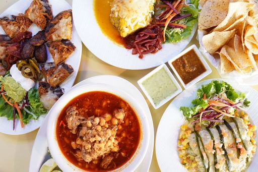 A top view shot of colorful different savory dishes on white plates