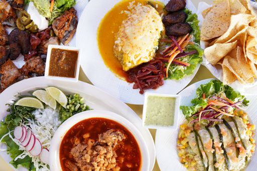 A top view shot of colorful different savory dishes on white plates