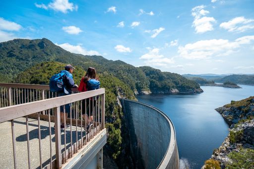 Wide view of majestic Gordon River Dam on a sunny fluffy cloud day. A popular attraction for visitors and tourists on a day trip
